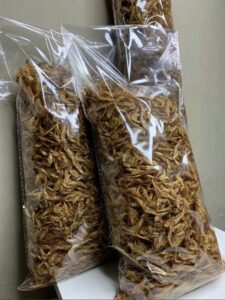 Nigerian small business owner preparing packaged goods for export neatly